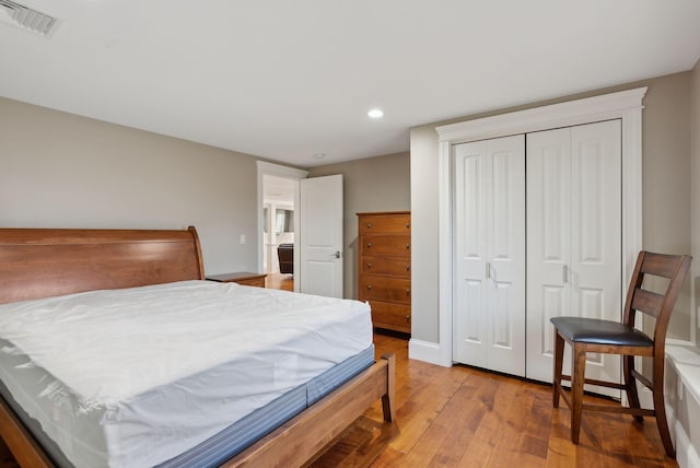 bedroom featuring wood-type flooring and a closet