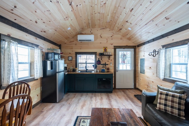 kitchen featuring stainless steel refrigerator, wood walls, and wood ceiling