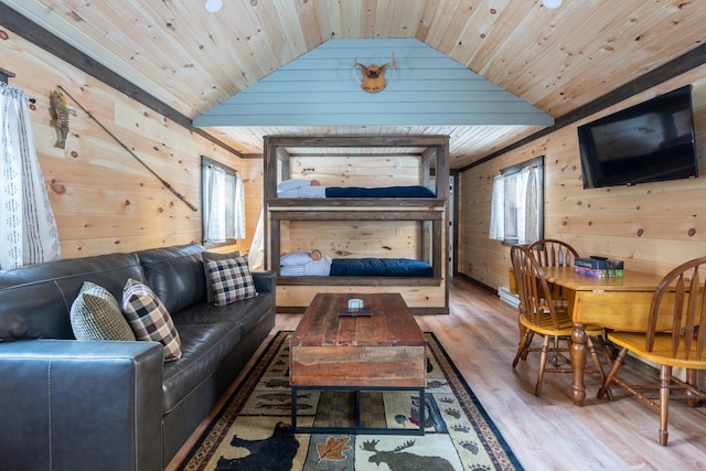 living room with wood-type flooring, lofted ceiling, wooden walls, and wooden ceiling