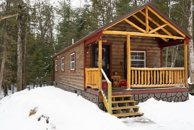 snow covered structure featuring a porch