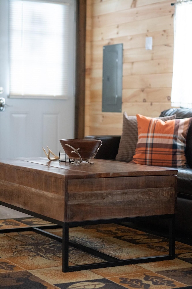 sitting room featuring electric panel and wooden walls