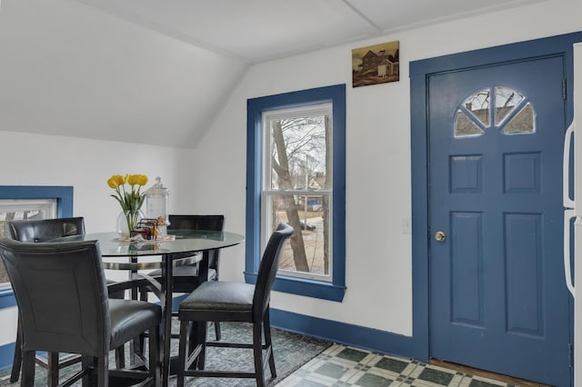 dining room featuring lofted ceiling