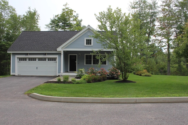 view of front of property featuring a front lawn and a garage