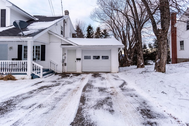 snow covered property with a garage