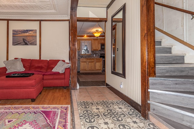 living room with crown molding and tile patterned flooring