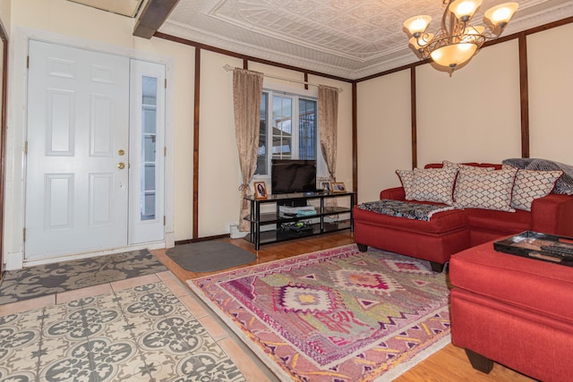 living room with a notable chandelier and crown molding