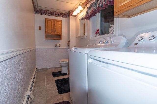 laundry area featuring independent washer and dryer, light tile patterned floors, and a baseboard radiator