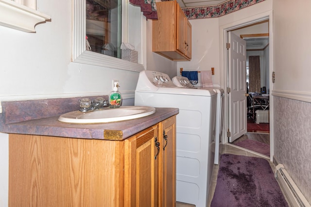 bathroom with radiator, baseboard heating, separate washer and dryer, tile patterned flooring, and vanity