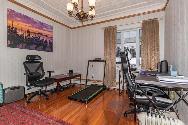 office with hardwood / wood-style floors, ornamental molding, and a notable chandelier