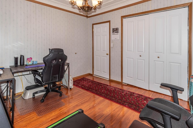 office space featuring hardwood / wood-style flooring, crown molding, and an inviting chandelier