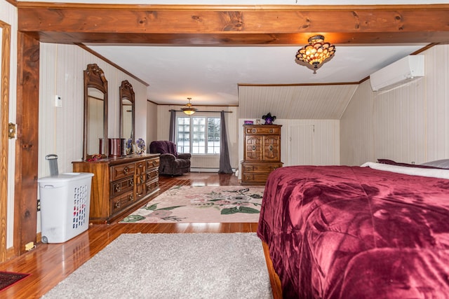 bedroom with wood walls, vaulted ceiling, light hardwood / wood-style flooring, baseboard heating, and a wall unit AC