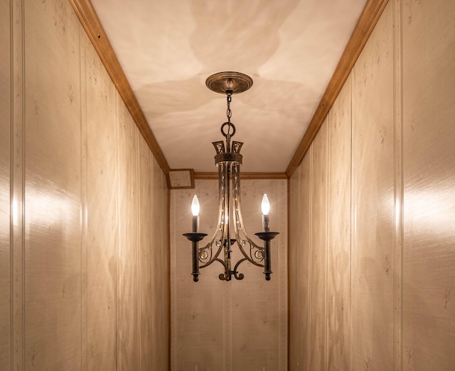 interior details featuring ornamental molding and an inviting chandelier