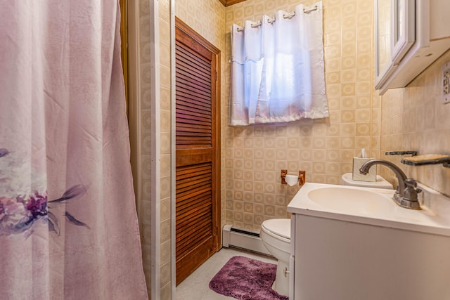 bathroom with vanity, toilet, and a baseboard heating unit