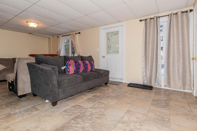 living room with a paneled ceiling