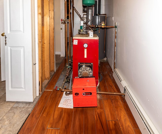 utility room with baseboard heating and water heater