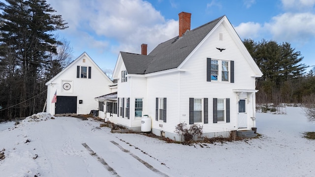 1153 Dexter Rd, Dover-Foxcroft, ME 04426 - view of snowy exterior featuring a chimney and entry steps
