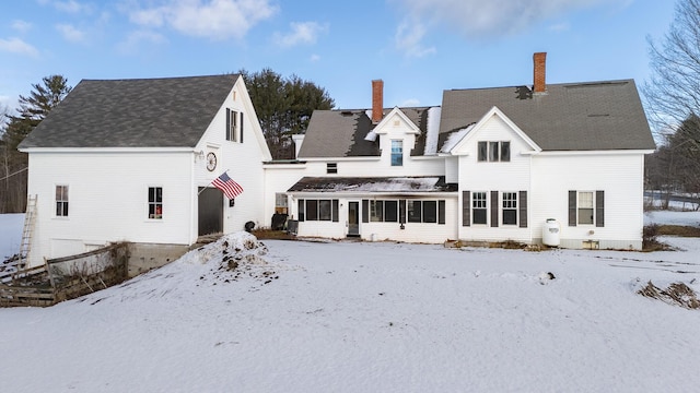 1153 Dexter Rd, Dover-Foxcroft, ME 04426 - snow covered rear of property with a sunroom and a chimney