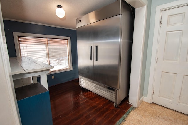 1153 Dexter Rd, Dover-Foxcroft, ME 04426 - detailed view of built in fridge, wood finished floors, ornamental molding, and a textured ceiling