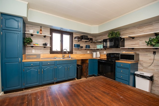 1153 Dexter Rd, Dover-Foxcroft, ME 04426 - kitchen with open shelves, black appliances, blue cabinets, butcher block countertops, and dark wood-style flooring