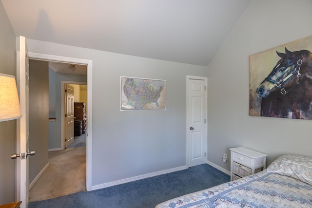 bedroom featuring dark carpet and vaulted ceiling