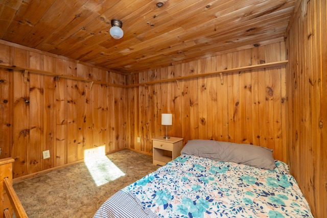 bedroom featuring wood walls, carpet, and wooden ceiling