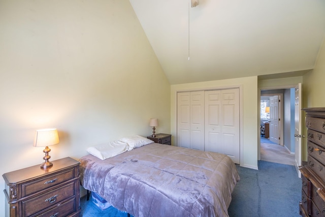 bedroom with vaulted ceiling, light colored carpet, and a closet