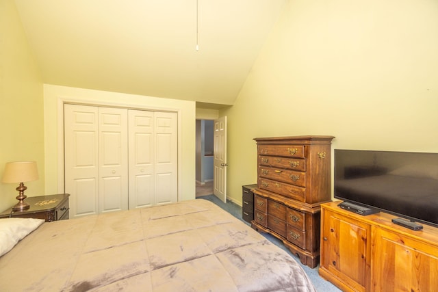 carpeted bedroom featuring a closet and vaulted ceiling