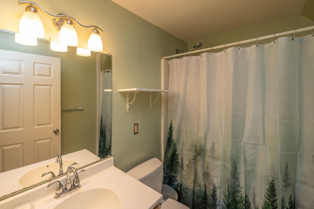 bathroom with vanity, toilet, and curtained shower