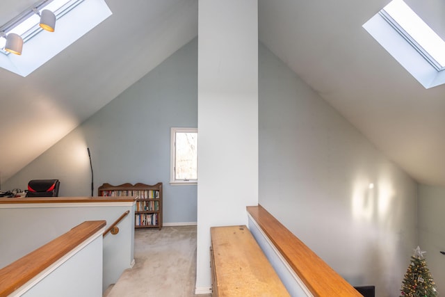 bonus room featuring light colored carpet and lofted ceiling with skylight