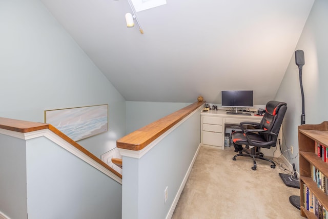 office area featuring light colored carpet and vaulted ceiling