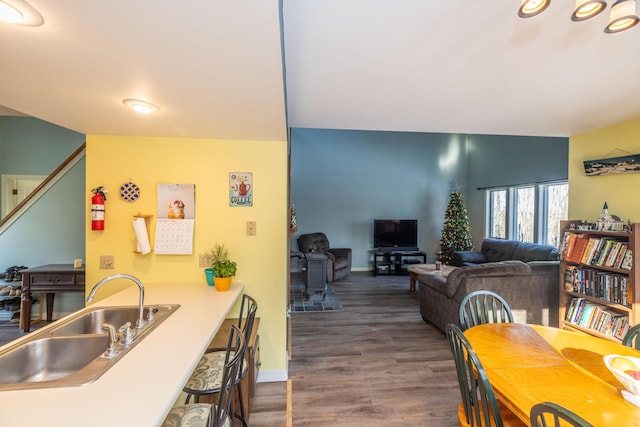 dining area with sink and dark wood-type flooring