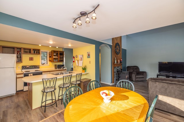 dining room featuring hardwood / wood-style flooring and sink