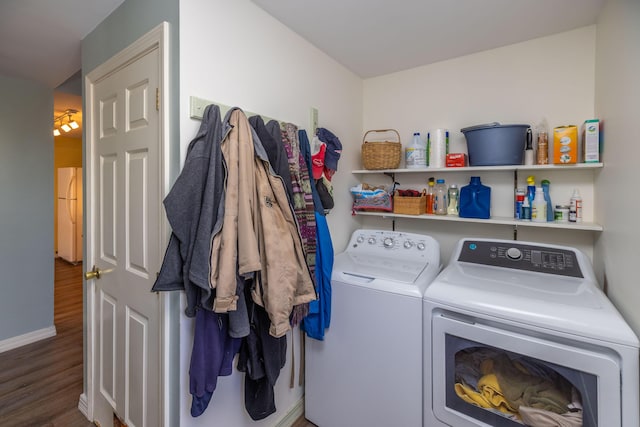 laundry area with washer and dryer and wood-type flooring