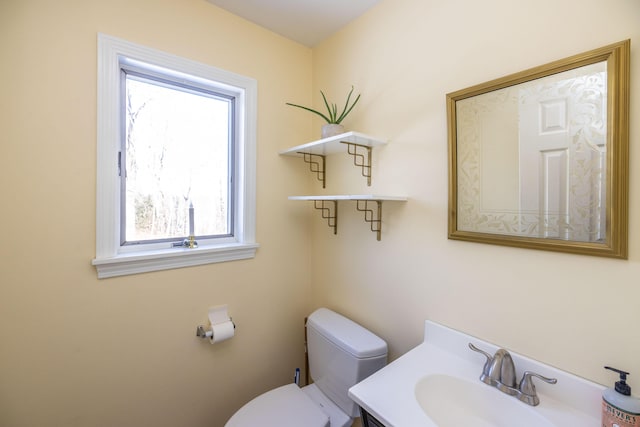 bathroom with a wealth of natural light, vanity, and toilet