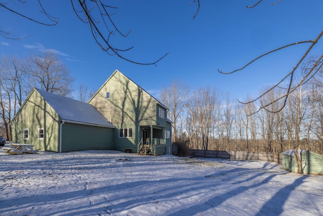 view of snow covered rear of property