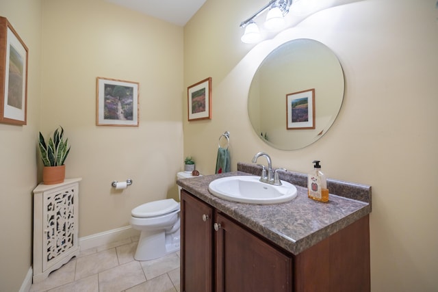 bathroom featuring vanity, tile patterned floors, and toilet