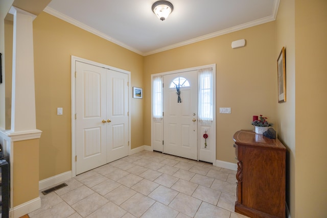 tiled foyer entrance with ornamental molding