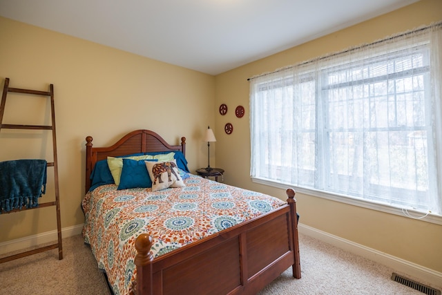 carpeted bedroom with multiple windows