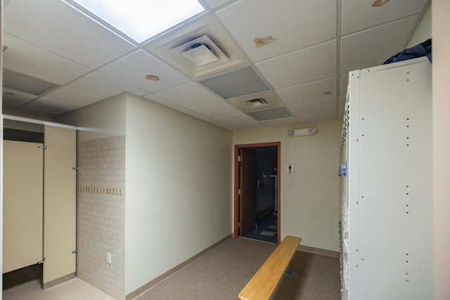 corridor with a paneled ceiling