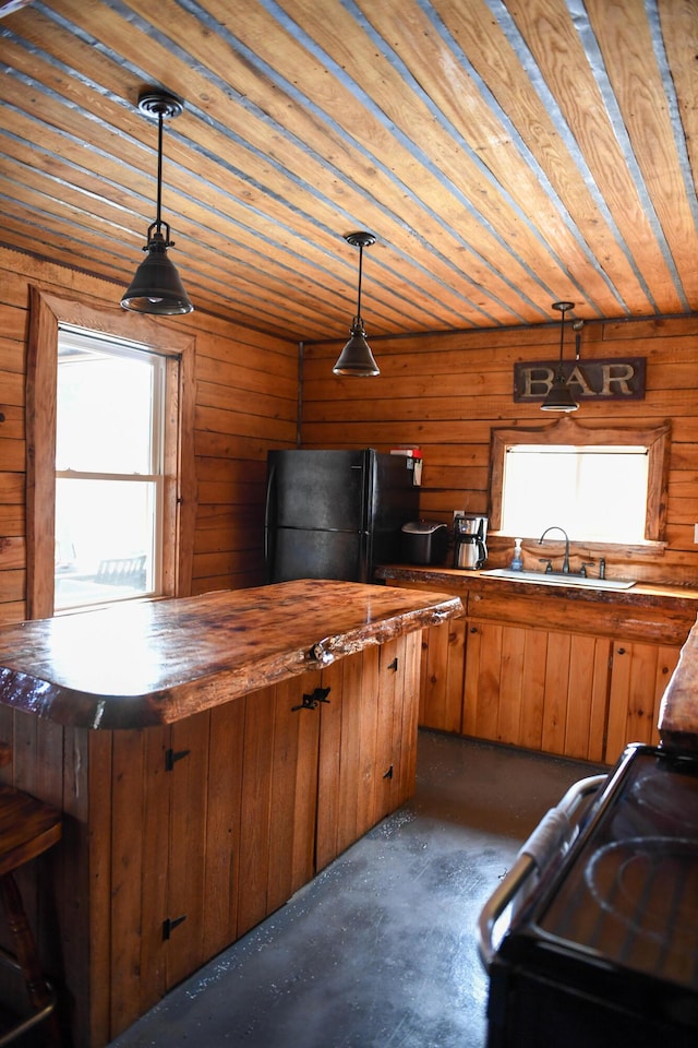 154 Old Brownville Rd, Sebec, ME 04481 - kitchen with black appliances, butcher block countertops, a sink, wood ceiling, and brown cabinetry