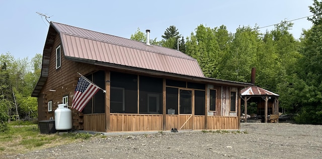 154 Old Brownville Rd, Sebec, ME 04481 - view of property exterior featuring a gambrel roof, a sunroom, and metal roof