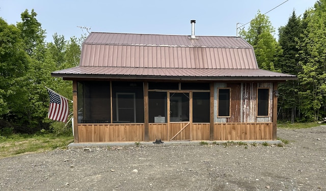 154 Old Brownville Rd, Sebec, ME 04481 - view of front of home featuring a gambrel roof, a sunroom, and metal roof