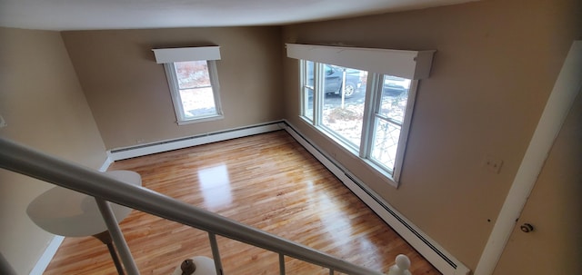 interior space featuring wood-type flooring and baseboard heating