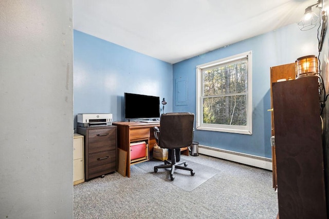 office space with light carpet and a baseboard heating unit