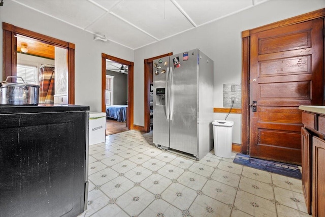 kitchen with stove and stainless steel fridge