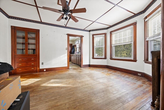 unfurnished living room with a healthy amount of sunlight, ceiling fan, and light hardwood / wood-style flooring