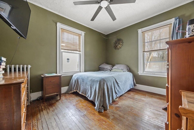 bedroom with radiator, a textured ceiling, ceiling fan, and hardwood / wood-style flooring