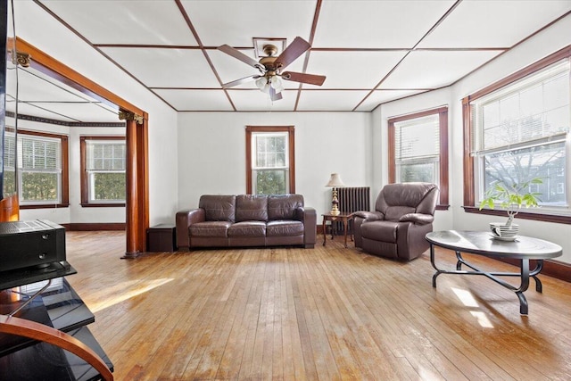 living room featuring ceiling fan and light hardwood / wood-style floors