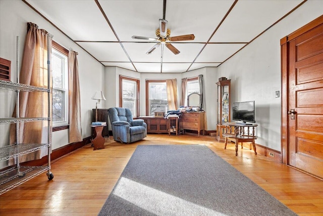 sitting room with light hardwood / wood-style floors and ceiling fan