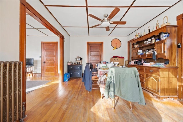 dining area with ceiling fan and light hardwood / wood-style floors